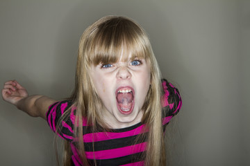 Young girl screaming at the camera