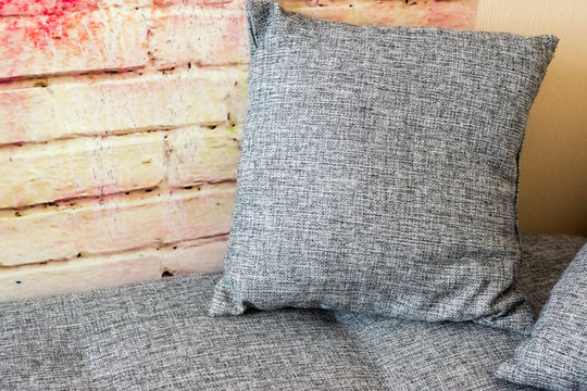 Cushion on the sofa near the wall
