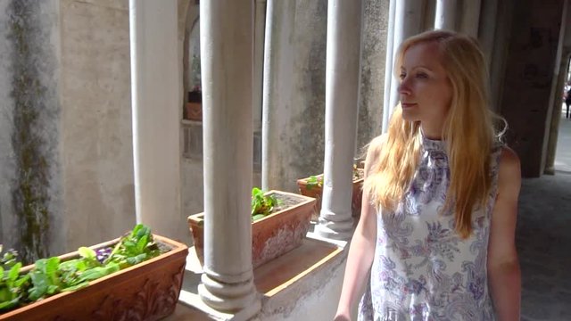 young blonde woman walking in Ravello at Italy