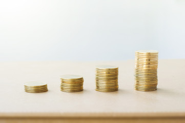 Wealth growing money rows of coins growth up on the table with white background in business finance and banking concept