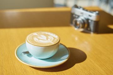 drink background of morning coffey in cafe at sunny day with analog camera on table