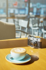 drink background of morning coffey in cafe at sunny day with analog camera on table