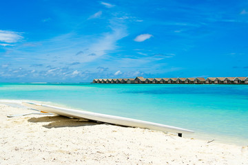 Fototapeta na wymiar Stand up paddle board - SUP boards on a sandy beach, Maldives