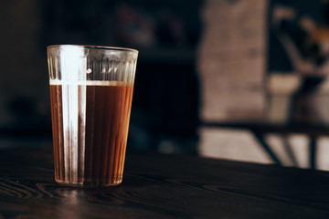 A glass of beer, a bar, a cafe, a table, alcohol