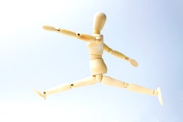 Wooden figure doll with jumping emotion for success business concept on white background