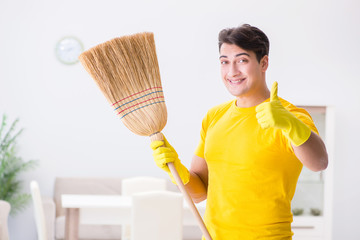 Young man doing chores at home
