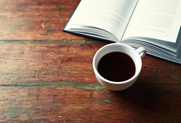 Cup of Black Coffee and an open Book