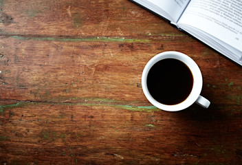 Obraz na płótnie Canvas Cup of Black Coffee and an open Book
