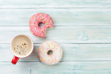 Coffee cup and colorful donuts