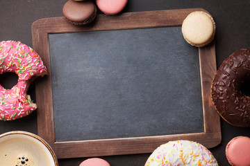 Chalkboard, coffee cup and colorful donuts