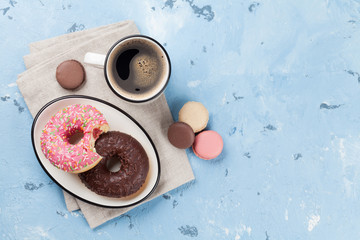 Coffee cup and colorful donuts