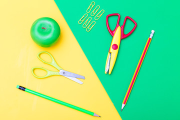 School supplies on a yellow-green background. flat lay