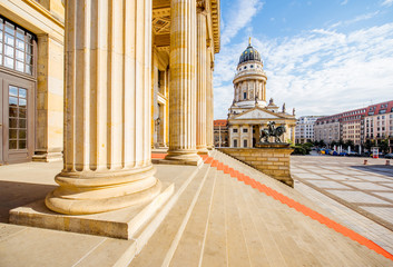 Viiew on the columns of the concert house building with German cathedral on the background during...