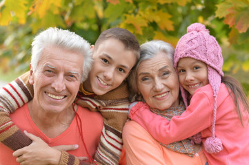 Fototapeta premium grandfather, grandmother and grandchildren in park 