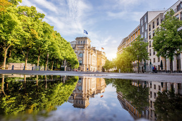 Street view with Reichtag building and beautiful reflection during the morning light in Berlin city - obrazy, fototapety, plakaty