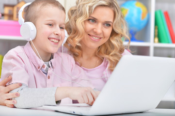 Mother and son using laptop