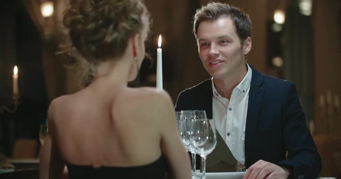 young couple in restaurant holding hands,a candlelight dinner, a guy to propose the girl