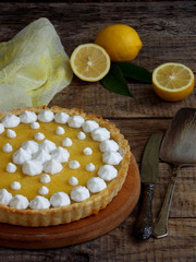 Obraz na płótnie Canvas Lemon tart pie with meringue cream. Homemade cake on wooden background.