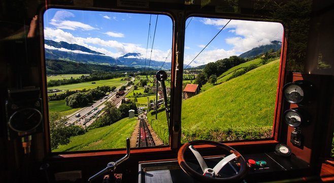 Begin your journey and discover switzerland with famous traditional swiss railway train ,  wander through beautiful swiss alpine scenery toward top of majestic mountain peaks in Switzerland, Europe.
