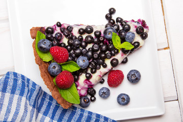 Delicious tart with blueberries and raspberries