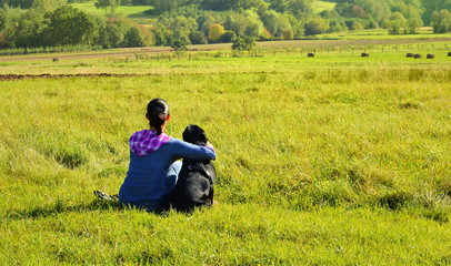 Young woman with her dog walking in the country