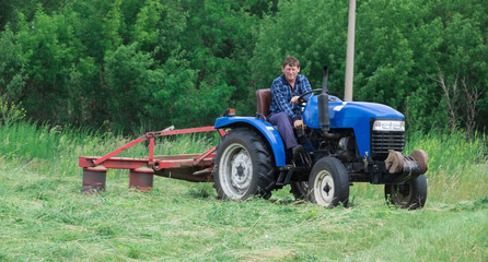 Man mowing grass in a field