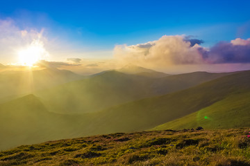 Panorama of mountain ridges with clouds and fog in the morning evening time, at sunrise, sunset