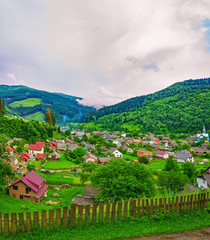 Village located on the slope of a mountain ridge, nature background, panorama