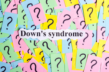 Down's syndrome text on colorful sticky notes Against the background of question marks