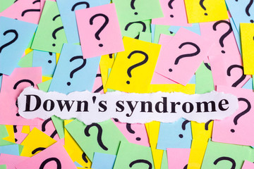 Down's syndrome text on colorful sticky notes Against the background of question marks