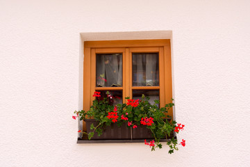 Fototapeta na wymiar Decorative traditional window of an Alpine house
