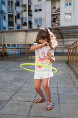 Little girl playing hula hoop