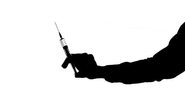 Moving male hands handling a syringe Black silhouette of male hands holding a clear syringe with the needle pointing up, then removing the cap and pushing the plunger up, against white background