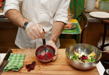 Chef is making salad dressing