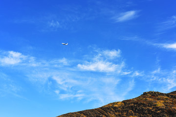 Small airplane above mountains.