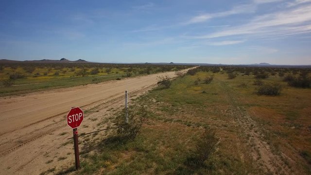Desert Dirt Road Aerial 10 Stop Sign Establish Shot