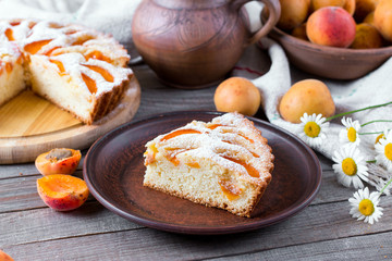 Obraz na płótnie Canvas Piece of apricot cake on wooden table