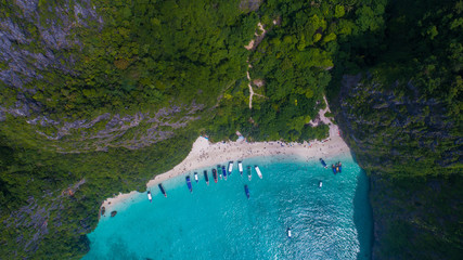 Aerial drone view of iconic tropical turquoise water Maya Bay surrounded by limestone cliffs, Phi Phi islands, Thailand