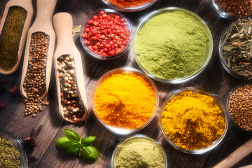 Variety of spices and herbs on kitchen table