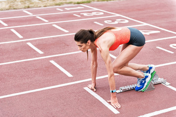 Serious young woman preparing for jogging