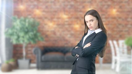 Young beautiful business woman and creative designer standing over blured interior background