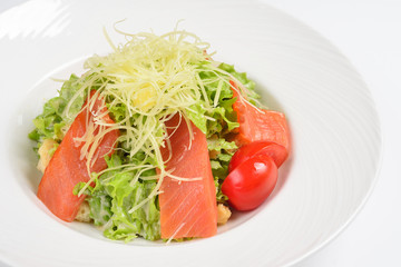 Caesar salad with smoked salmon. White background, menu concept.