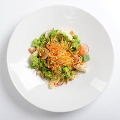 Warm salad with squid, vegetables with grape sauce. White background, menu concept. Flat lay.