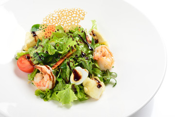 Salad with shrimps, Camembert cheese with French sauce. White background, menu concept.