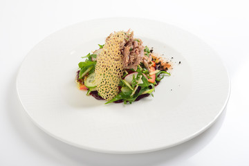 Creative salad with a duck-confit in a French refueling. White background, menu concept.