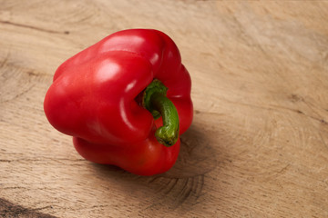 Sweet bulgarian red bell pepper on wooden background