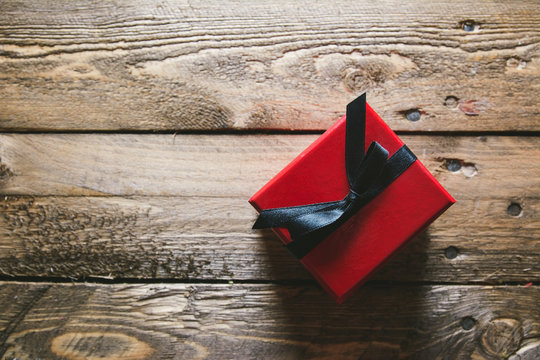 Red Gift box, on wooden table