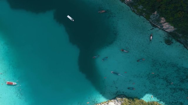 Aerial drone view of iconic tropical turquoise water Pileh Lagoon surrounded by limestone cliffs, Phi Phi islands, Thailand
