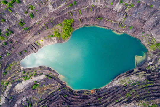 aerial view of deep mine lake in place of the mining pit