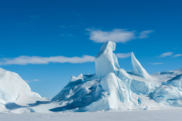 A jagged iceberg frozen into the sea ice in the Weddell Sea Antarctica.